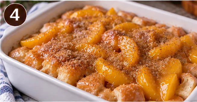 Doughnuts and peach mixture layered in a baking dish before baking