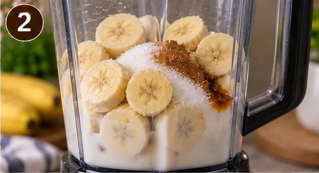 Banana chunks, sugar, and cinnamon in a blender