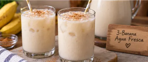 Two glasses of chilled banana agua fresca garnished with cinnamon