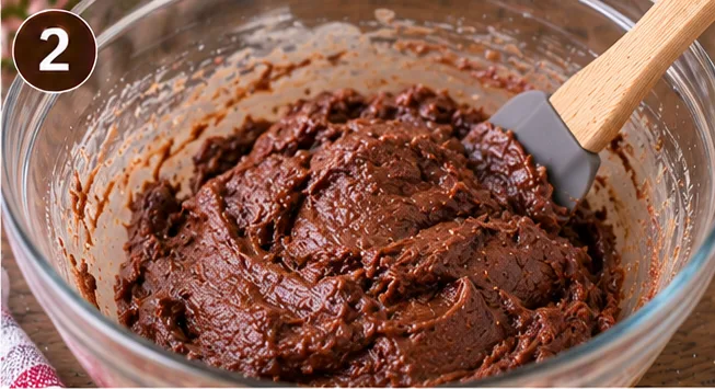 Nutella cookie dough mixed together in a glass bowl