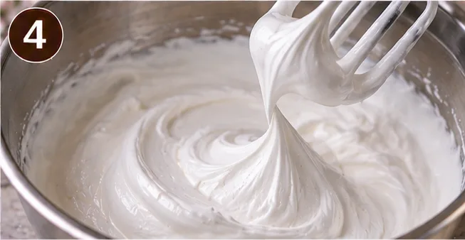 Thick, glossy 7-minute frosting holding stiff peaks