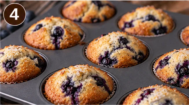 Baked blueberry muffins fresh out of the oven in a muffin tin