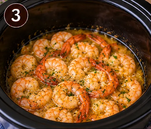 Shrimp cooking in garlic butter sauce in the slow cooker